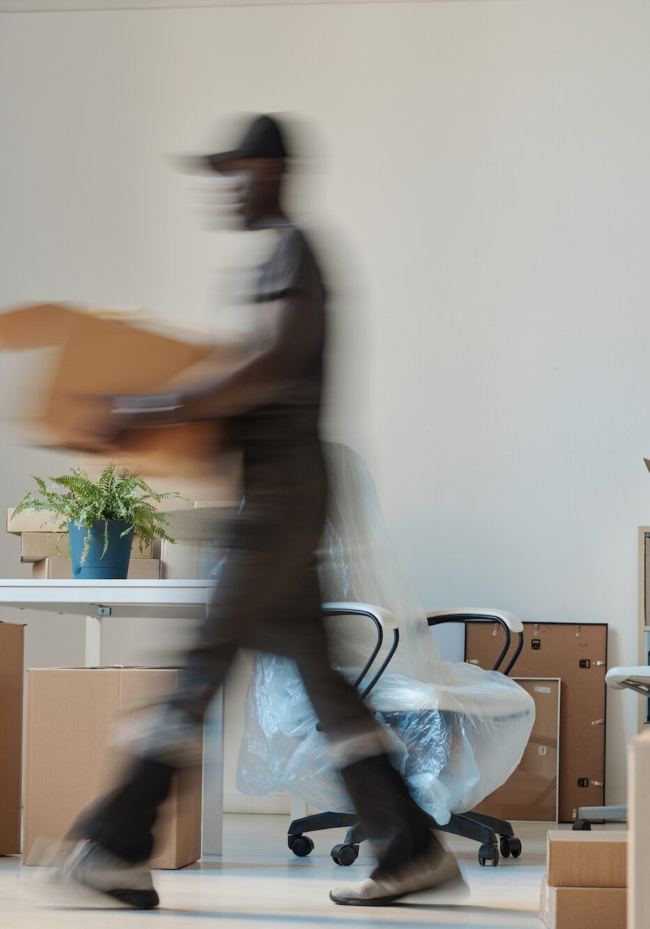 Worker carrying boxes during relocation
